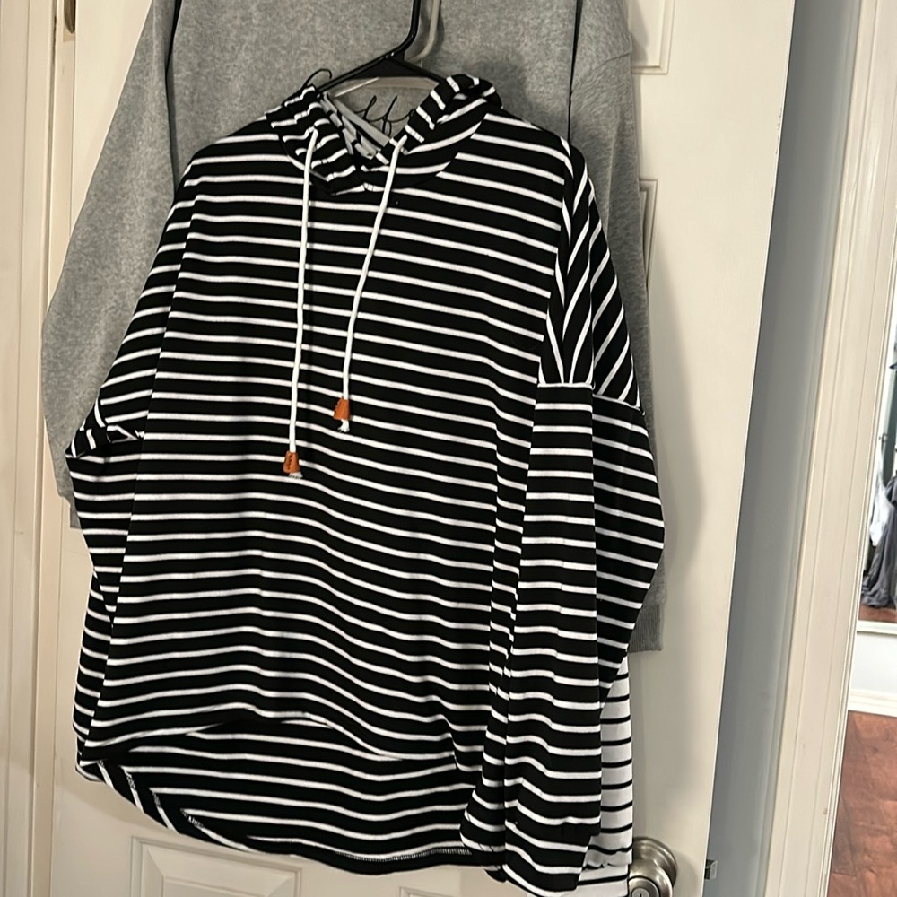 Brand new long sleeve shirt. A littlee longer in the back. Has a hood.